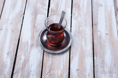 A high angle shot of a glass of tea on a wooden tableの写真素材