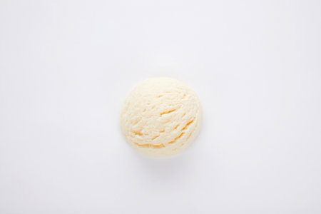 Atop view of a delicious vanilla ice cream scoop isolated on a white surfaceの写真素材