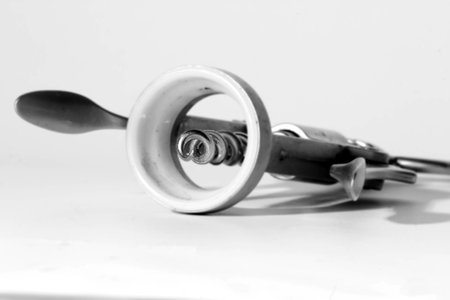 The black-and-white photo of a metallic corkscrew on a white backgroundの写真素材