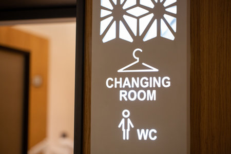 The signs for "Changing room" and male WC on the wallの写真素材