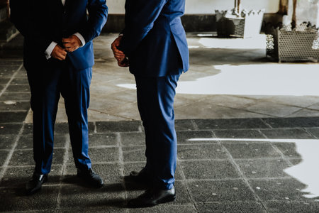 Two men with suits standing outdoorsの写真素材