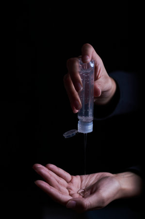A vertical shot of a sanitizer pouring out into a handの写真素材