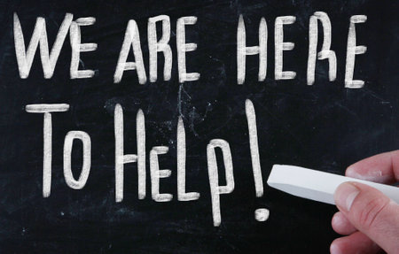 A closeup shot of a white text "We Are Here To Help!" on a black surfaceの写真素材