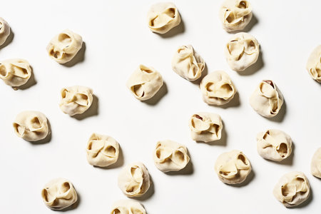 A top view of delicious homemade manti dumplings on a white surfaceの写真素材