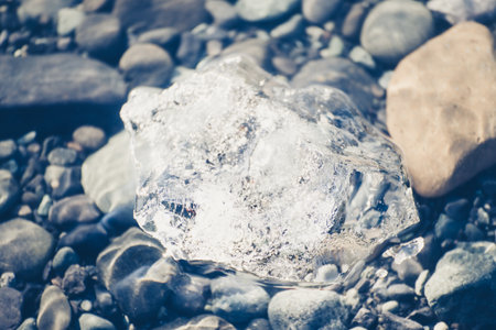 A closeup of the crystal clear little icebergs floating on the water in Icelandの写真素材