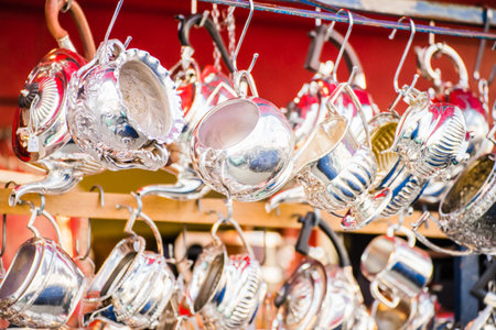 A stand with different shiny metal kitchenware hanging from the hooksの写真素材