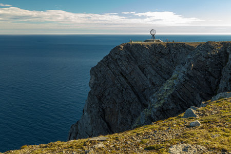 A shot of a high cliff with blue sea on the backgroundの写真素材