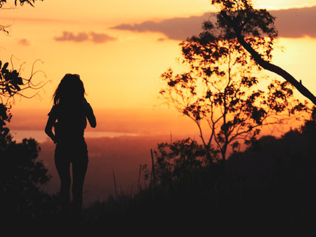 A wonderful silhouette of a girl on beautiful sunset in Indonesia, Baliの写真素材