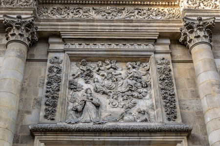 A low angle shot of the engravings on the Church of Notre Dame under the sunlight in Bordeaux, Franceの写真素材