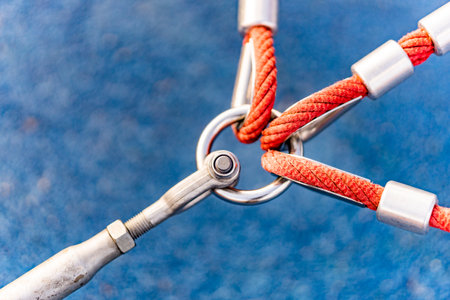 A closeup shot of three red ropes attached to a ringの写真素材