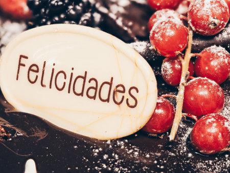 A closeup of a delicious chocolate birthday cake with a Congratulations topper