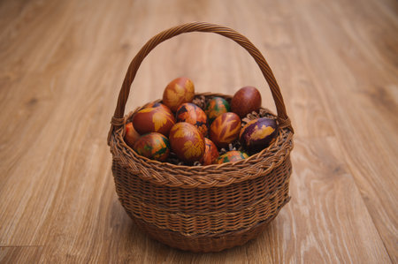 A closeup shot of colorful Easter eggs in a wooden basketの写真素材