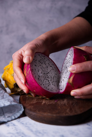 Dragon fruits cut out and exposed on dark backgroundsの写真素材