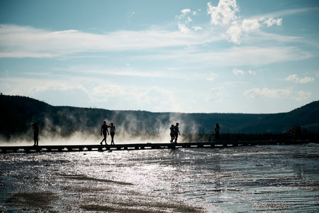The silhouettes of tourists at the Yellowstone National Parkの写真素材