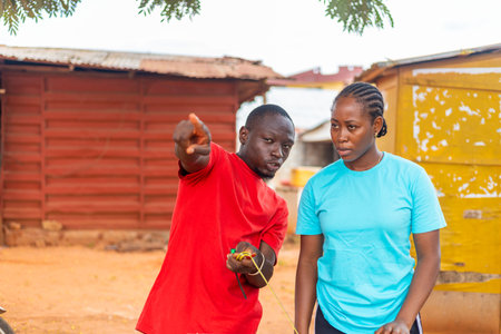 An african carpenter explaining to his clientの写真素材