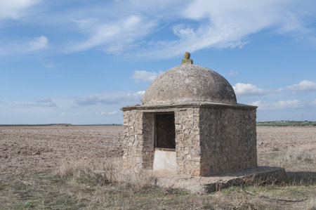 An old and exotic well captured in the middle of a farm on a sunny dayの写真素材