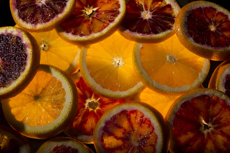 A top view of juicy orange slices arranged as a background