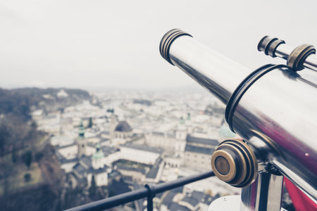 A binocular with the Salzburg cityscape in the backgroundの写真素材