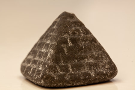 A closeup shot of pyramid chocolate on a white backgroundの写真素材