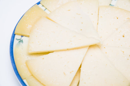 A plate with slices of Spanish manchego cheeseの写真素材