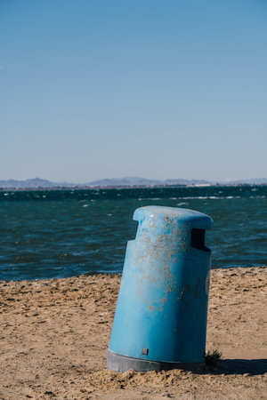 A vertical shot of a rusty metal trash can in Mar Menor, Cartagena, San Javier, Murcia, Spainの写真素材