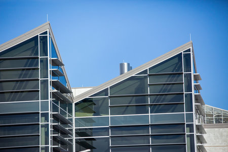 A closeup shot of a modern building under a blue sky