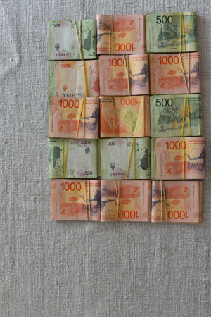flatlay of argentine peso 500 and 1000 peso banknotes, symbol of inflation