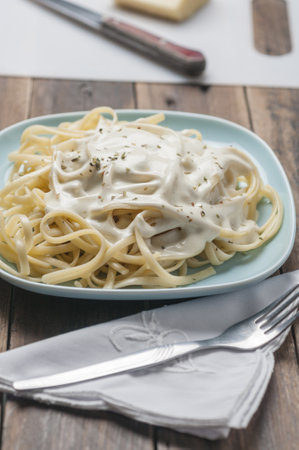 A vertical shot of spaghetti with cheese sauceの写真素材