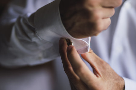 The groom buttoning cuffs of the shirtの写真素材