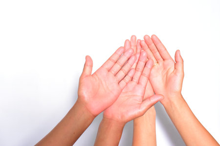 The hand palms of Four people isolated on a white backdropの写真素材