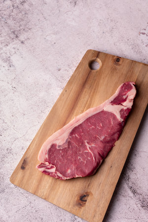 A top view of a fresh raw veal chop on a wooden kitchen boardの写真素材
