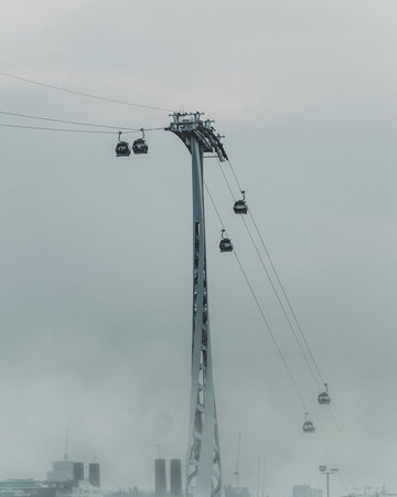 A vertical shot of ropeway on a foggy dayの写真素材