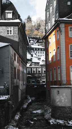 A vertical shot of scenic European architecture and a canal of water going through the buildingsの写真素材