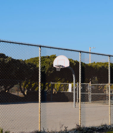 An empty basketball court outside at the beach on a sunny day
