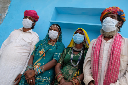 A group of Indian people in national costumes wearing face masks during the COVID-19 pandemicの写真素材