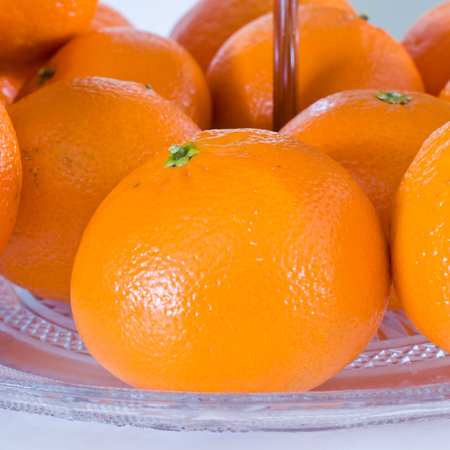 A closeup shot of fresh ripe oranges on a plateの写真素材