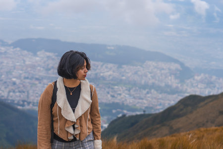 A young female hiking in mountains and enjoying the beautiful viewの写真素材