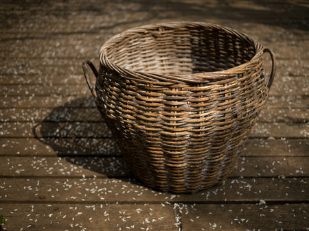 A brown basket standing on a wooden terraceの写真素材