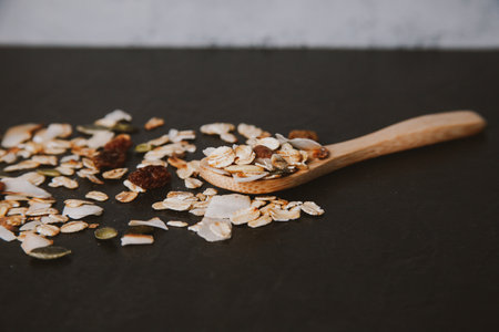 A healthy and delicious spooned muesli on a black backgroundの写真素材