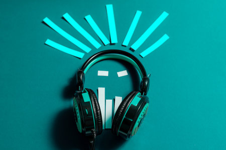 Modern headphones on a blue background with sound wavesの写真素材