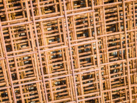 A closeup of the rusty weathered metallic rebars in the construction areaの写真素材