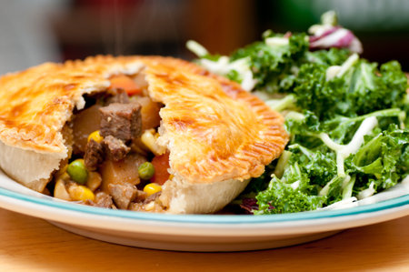 kale salad and beef pot pie with flaky crustの写真素材