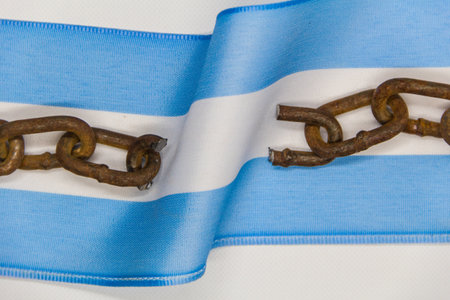 Broken chains on the Argentine flag. Concept of revolution and national independenceの写真素材