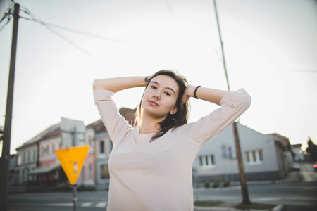 A closeup shot of a beautiful white Caucasian girl posing on a blurred background