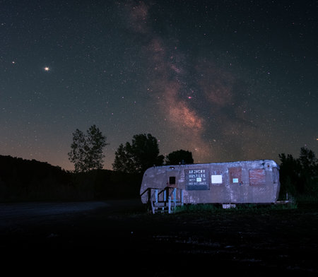 A cabin wagon house in the woods under the starry skyの写真素材