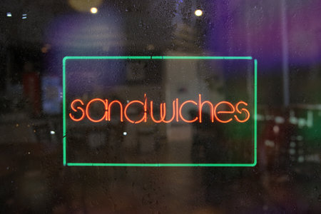 vintage neon Sandwiches sign in wet windowの写真素材