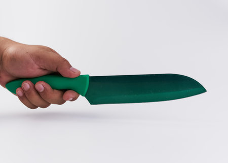 A person holding a knife isolated on a white backgroundの写真素材