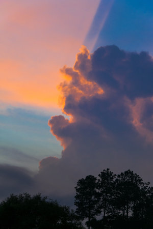 Big Cumulonimbus clouds over rural Guatemala at sunset, blue sky, dramatic image.の写真素材