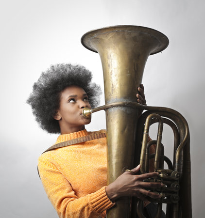 young woman plays a trombone