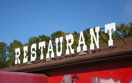 Restaurant Sign on Building Roofの写真素材